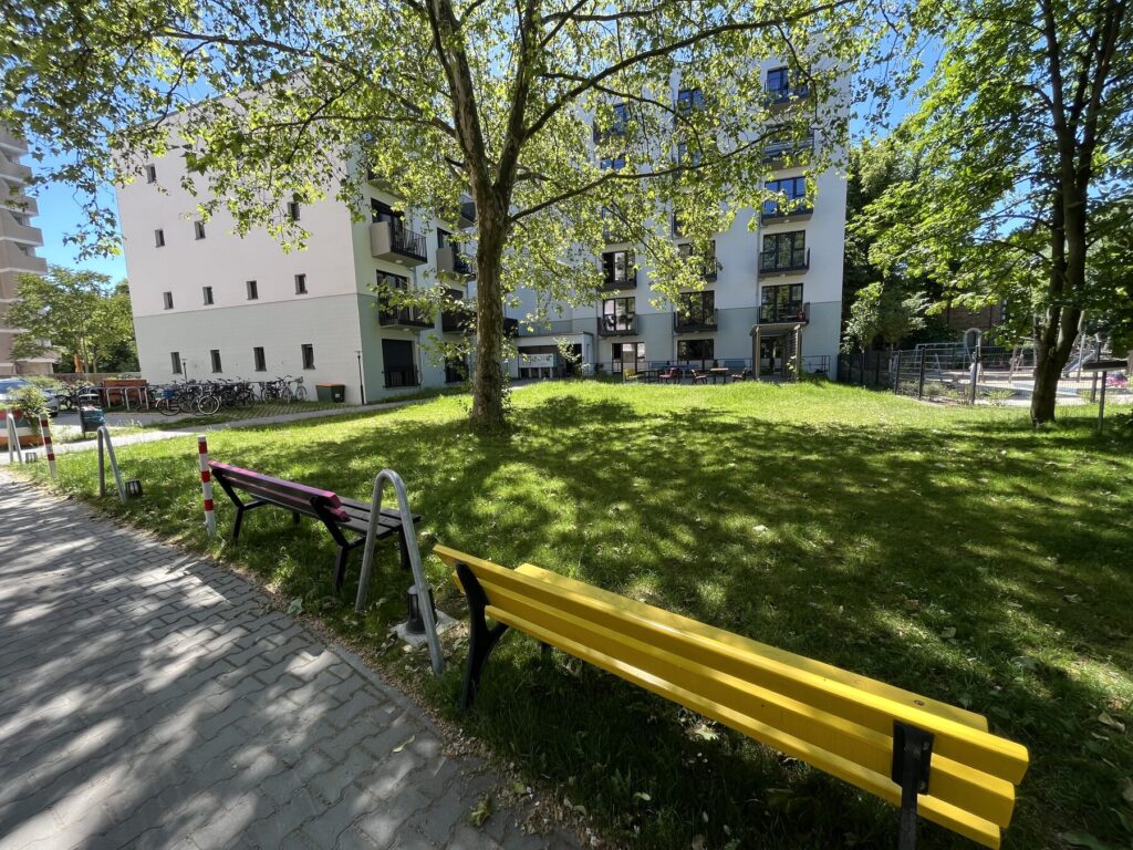 Yellow bench in the greenery